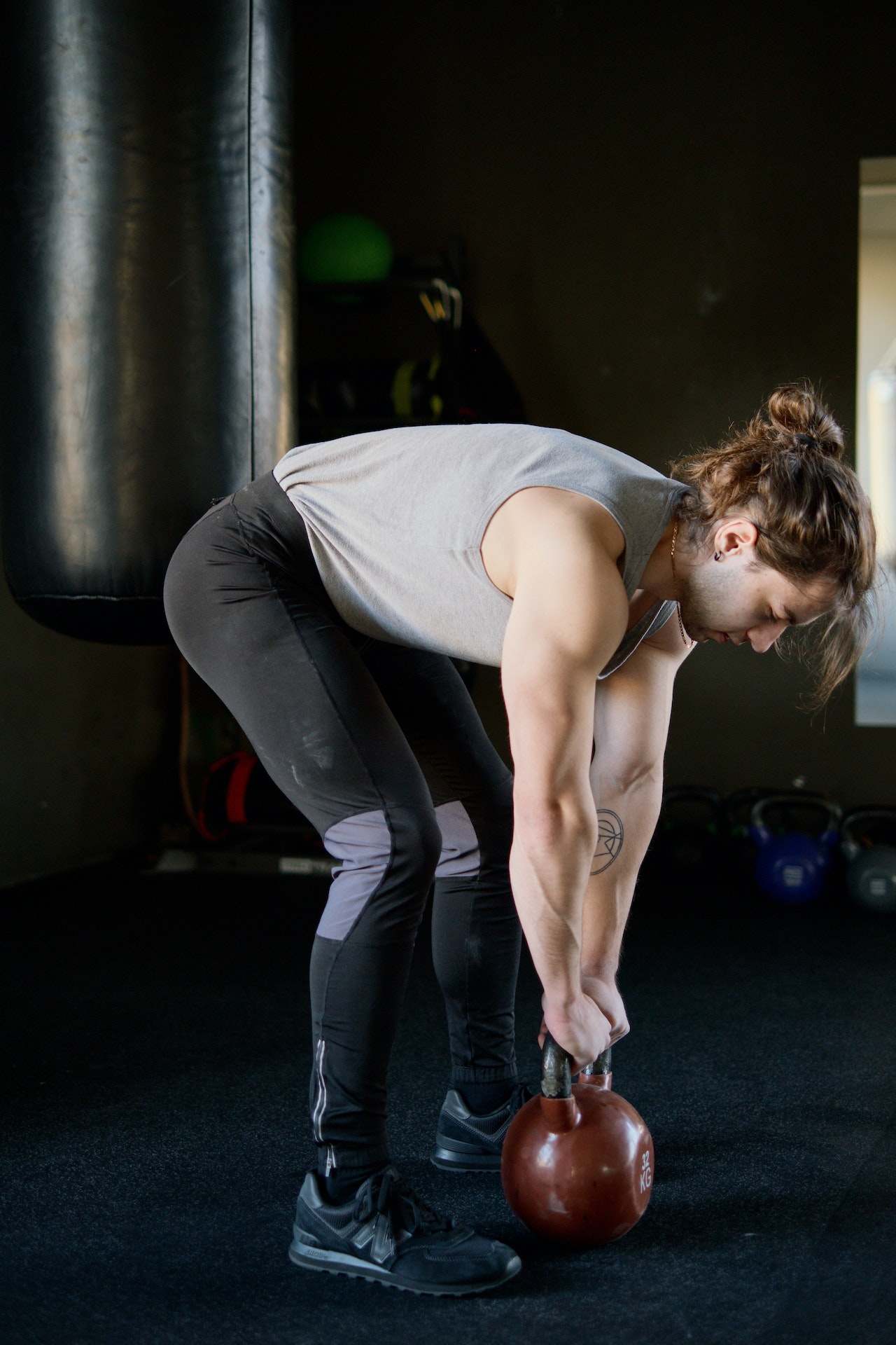 Photo by Ivan Samkov: https://www.pexels.com/photo/man-in-gray-tank-top-lifting-a-kettlebell-4162445/