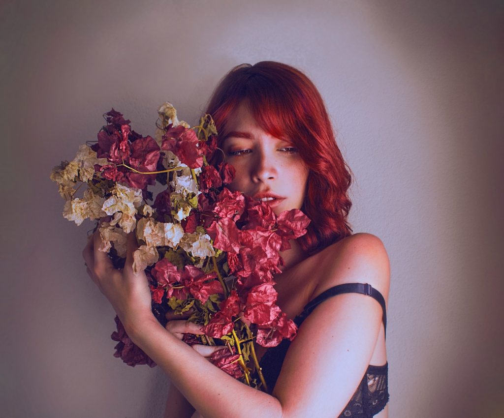 Photo by Paz shots: https://www.pexels.com/photo/standing-woman-holding-white-and-red-petaled-flowers-3025594/
