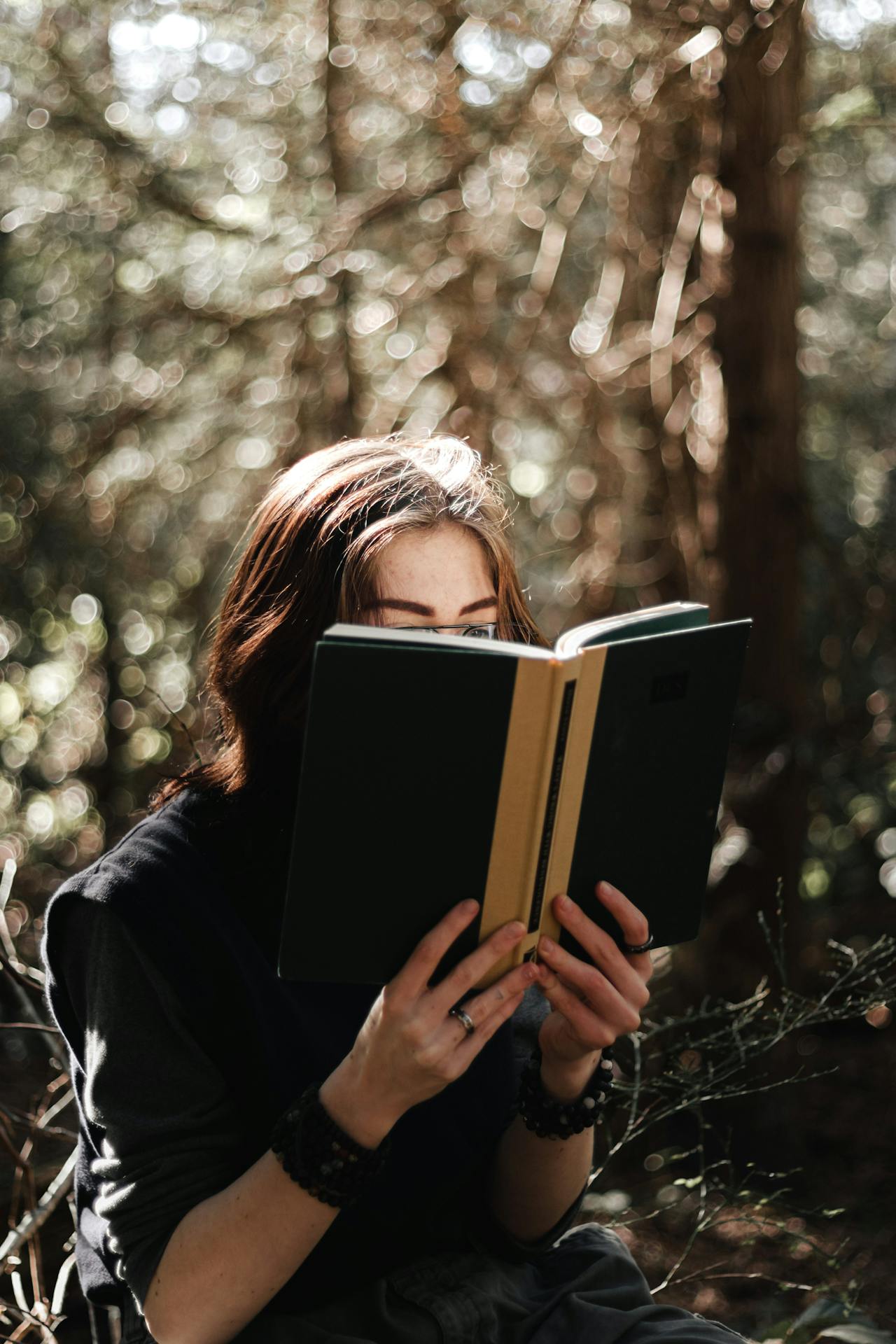 Photo by Aedrian: https://www.pexels.com/photo/photo-of-a-woman-with-a-ring-holding-a-black-book-11482152/